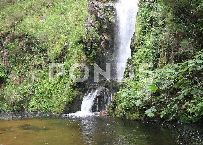 Pozo da Ferida falls in the middle of nature in Viveiro... | Stock Video | Pond5 photo