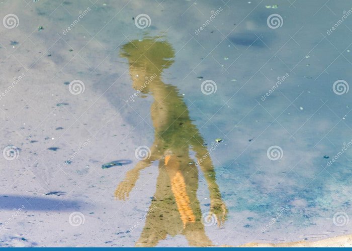 Ondina Beach Reflection of a Person in the Puddle of Water at Ondina Beach ... photo